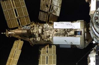 Survey views of the Mir space station taken by the crew of the STS-86 orbiter Atlantis including Spektr module with the damaged radiator and solar array SP#1 visible.